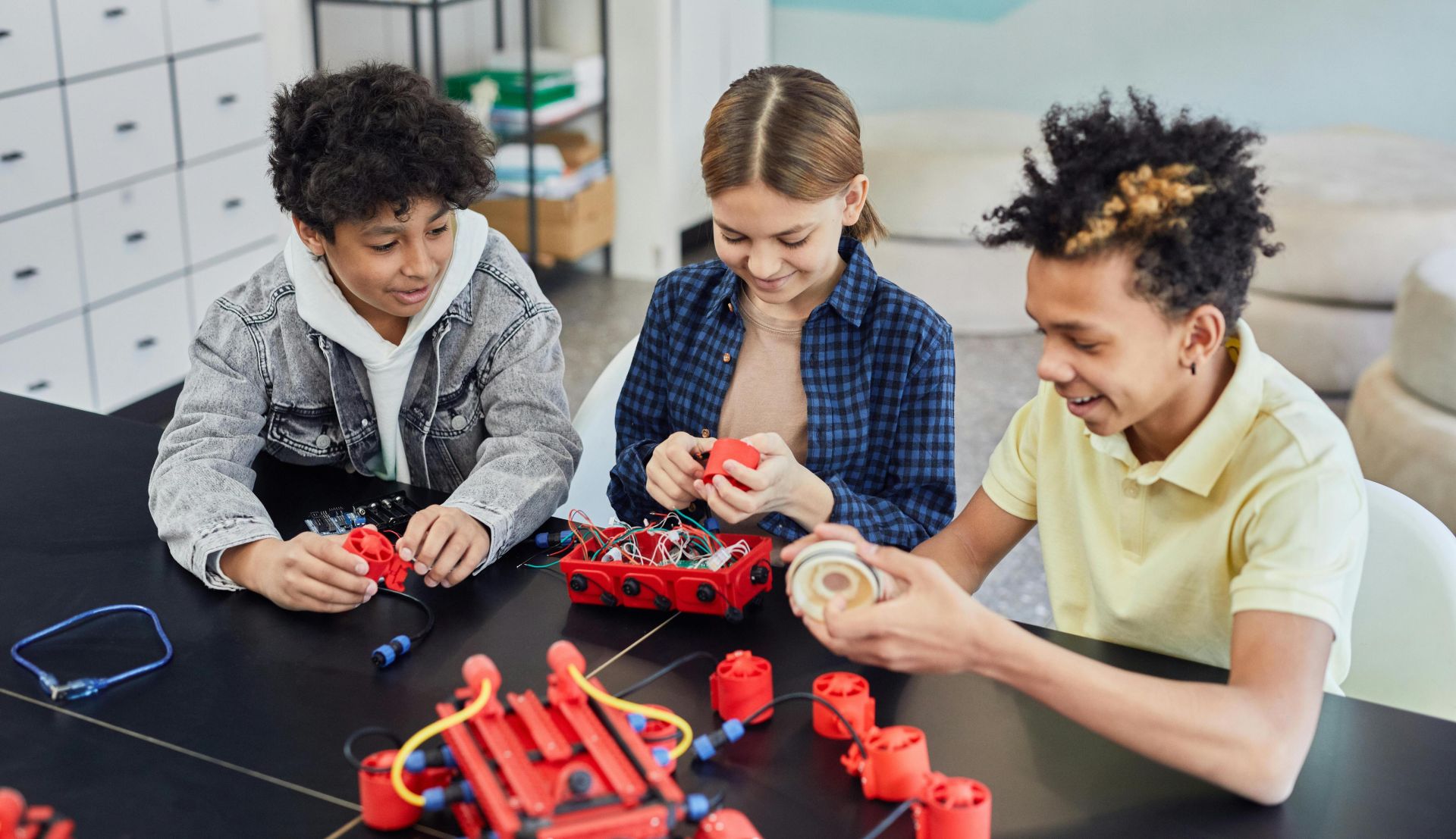 Children collaborating on a robotics project, showcasing teamwork and STEM learning indoors.